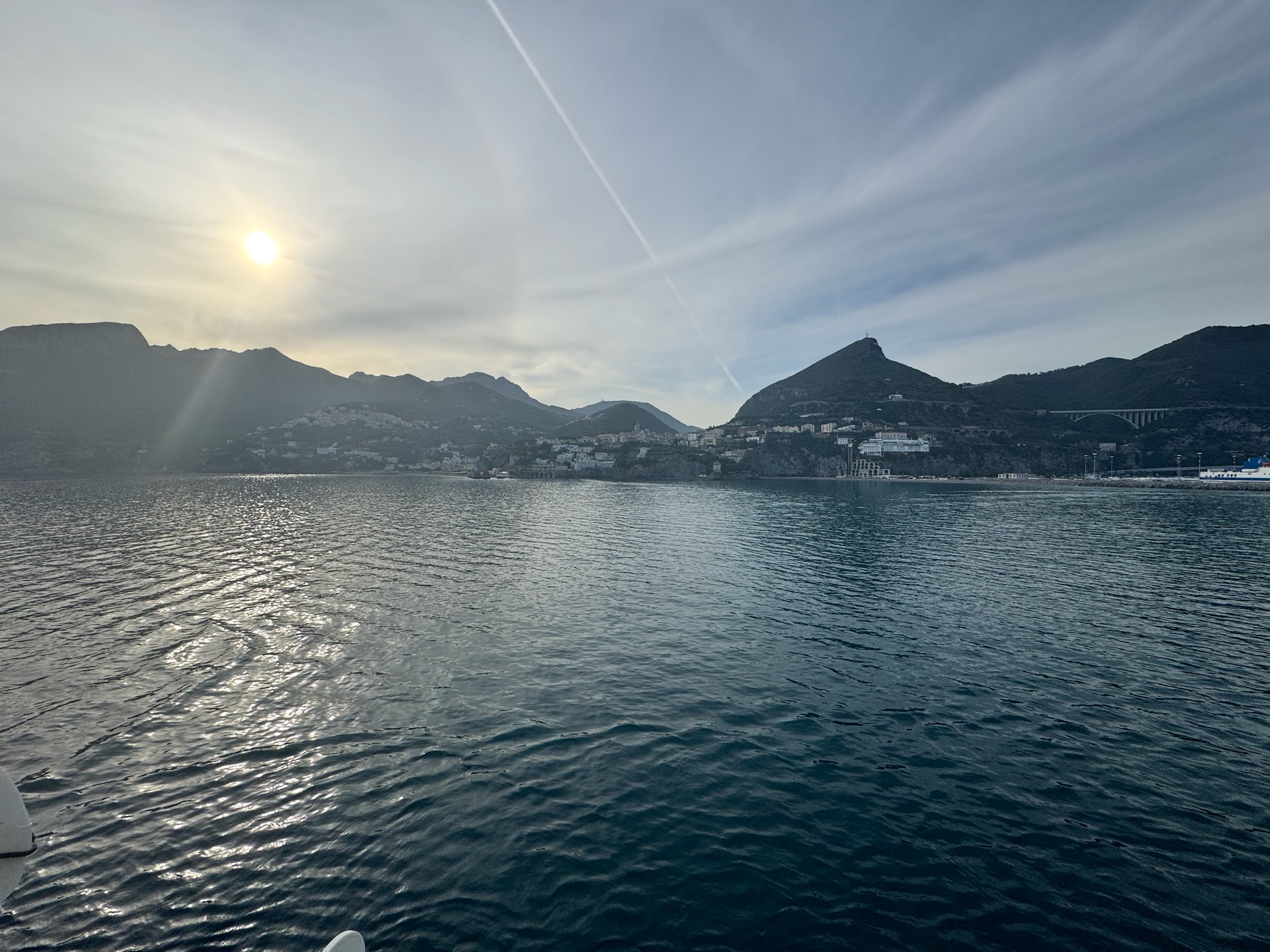 Sunset over the water and mountains along the Italian coast