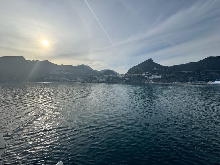 Sunset over the water and mountains along the Italian coast
